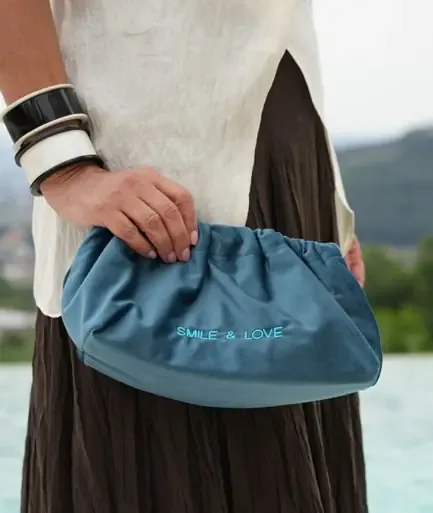 Clutch em veludo segurada à mão
